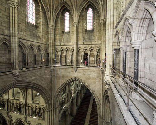 View of inside of cathedral tower with stone arches, taken from high up.