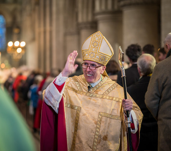 Peter Collins clergy waving in isle.