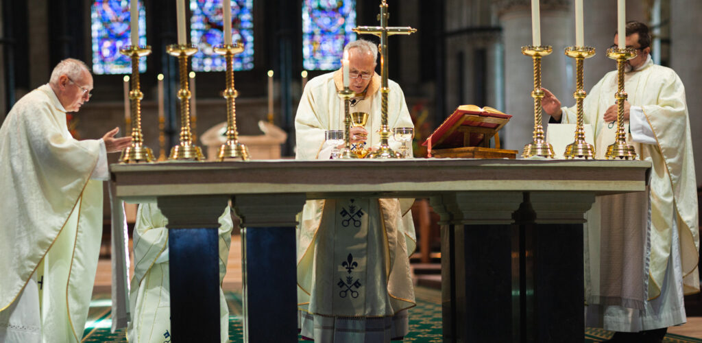 Clergy with candles and bible.