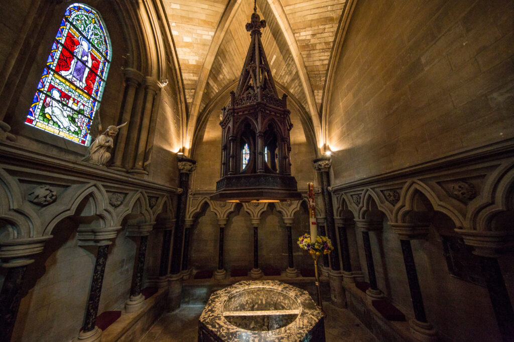 Cathedral marble font with stained glass window.