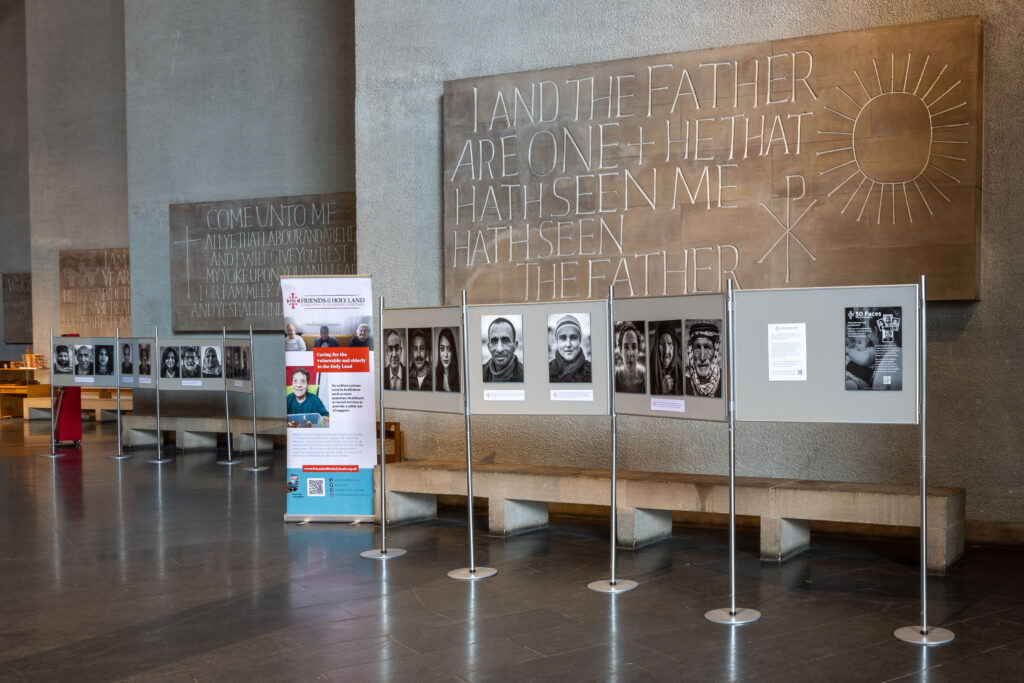 Exhibition of black and white portraits in cathedral space.