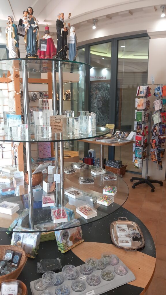 Circular glass shelves containing religious trinkets and souvenirs.